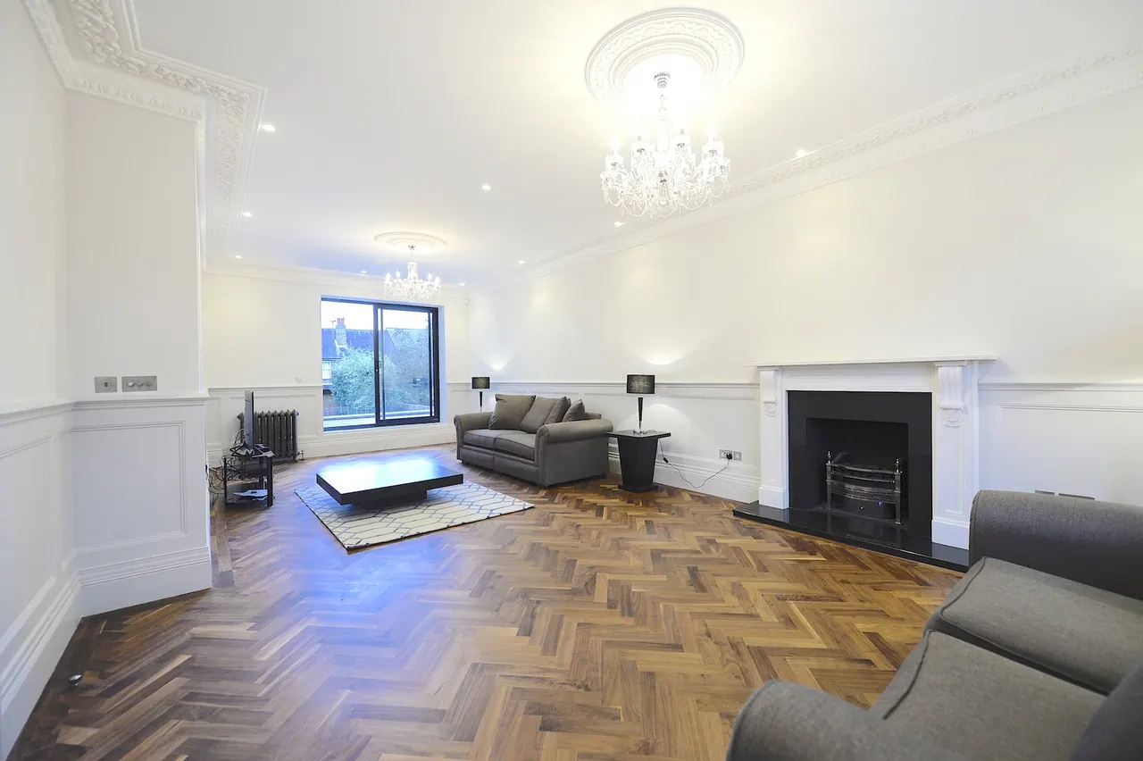 Reception room with restored fireplace and herringbone flooring