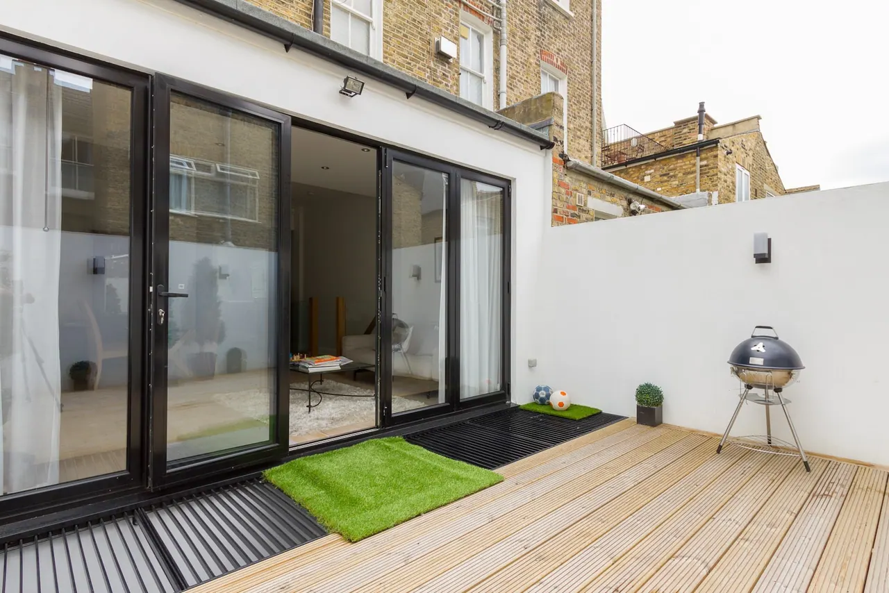 Courtyard and decking beyond the new glazed opening